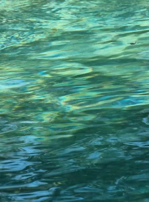 Clear turquoise water rippling across the natural swimming pool