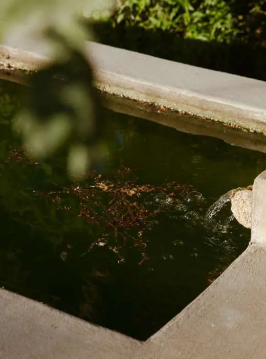 Water spilling into one of the old stone irrigation tanks